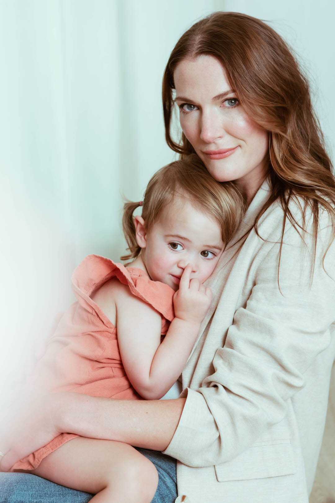 Mom holding her daughter toddler in her lap