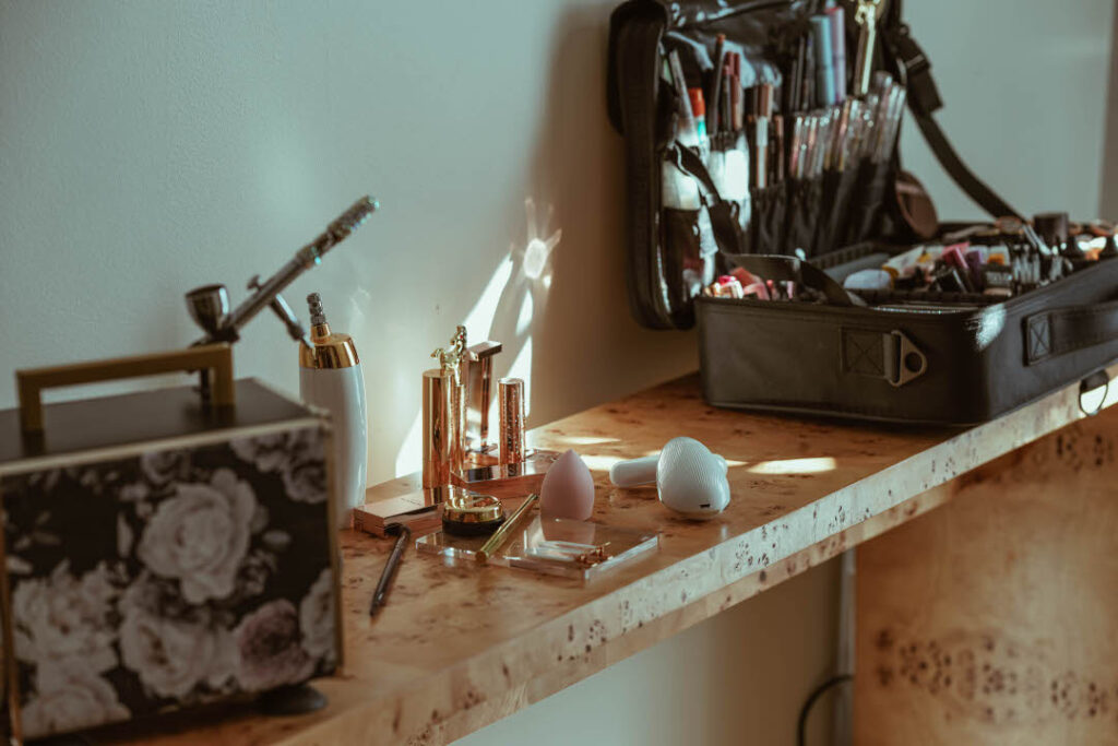makeup station with a makeup kit and airbrush machine. professional portrait transforming self image
