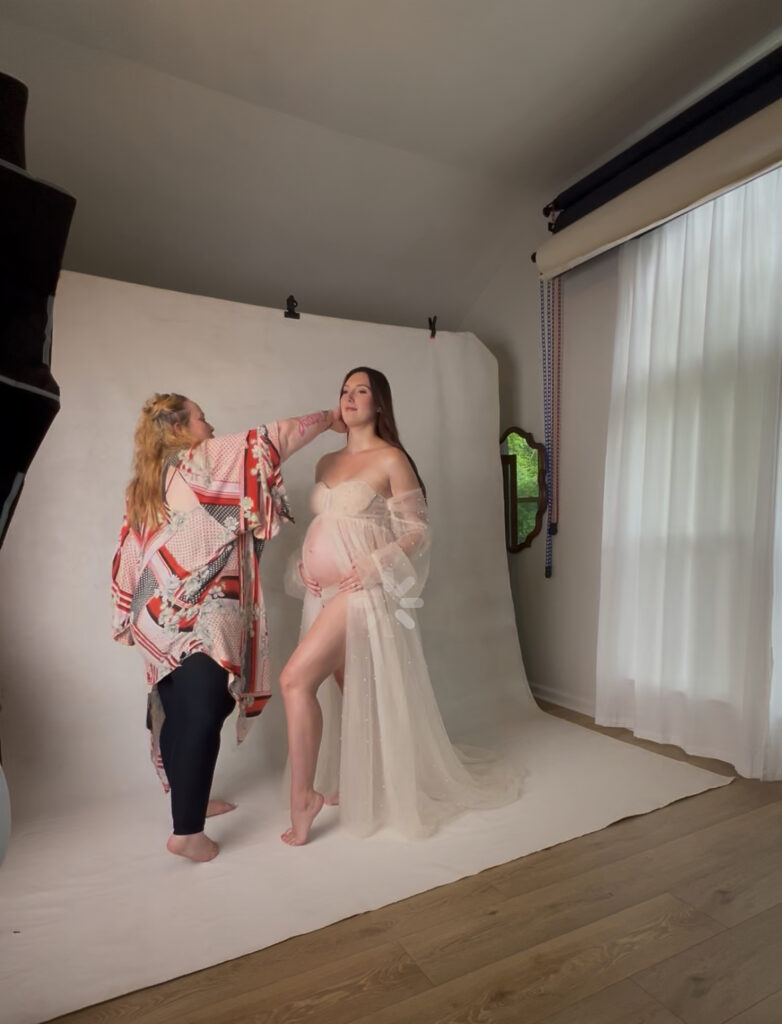 photographer jamine ringo helping client look her best during maternity session in her Stone Mountain GA studio. professional portrait transforming self image