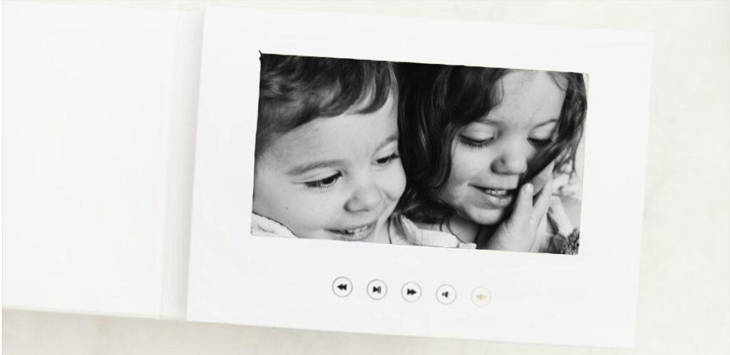a motion book displaying the inside look at a movie book that displays a short video from a family photo session or a maternity photoshoot or a newborn photography session
