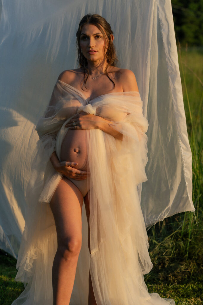 Close-up of glowing mother-to-be with golden light in maternity sunset photos
