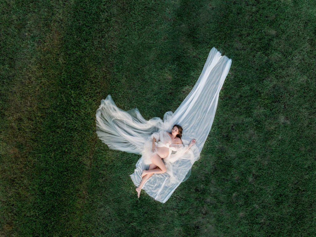 Cinematic aerial drone shot of maternity sunset photos in open fields
