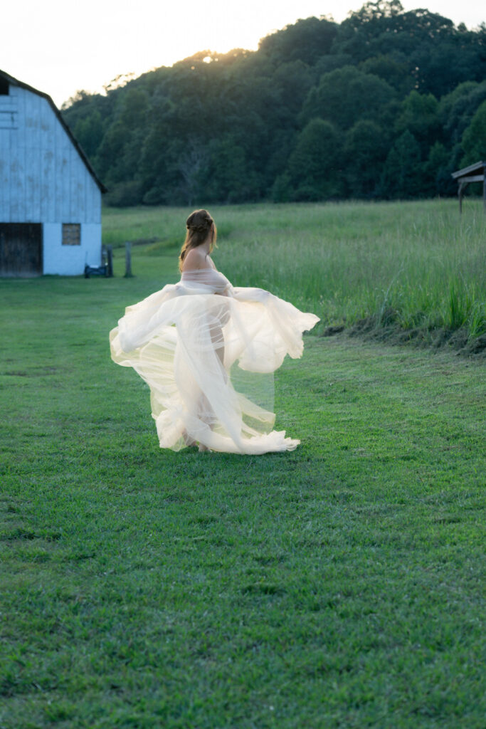 Flowing dress catching golden hour light in outdoor maternity sunset photos
