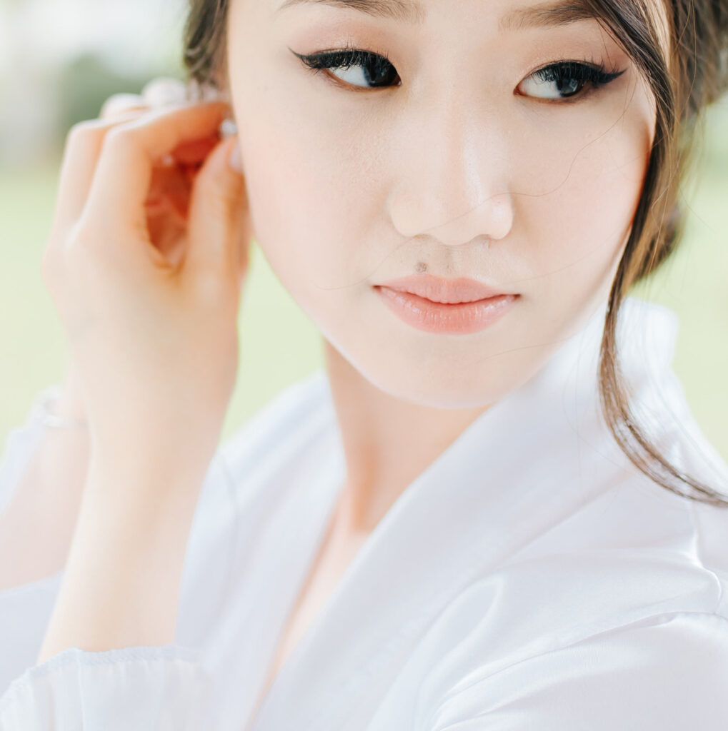 close up of asian bride with makeup by Jasmine Ringo