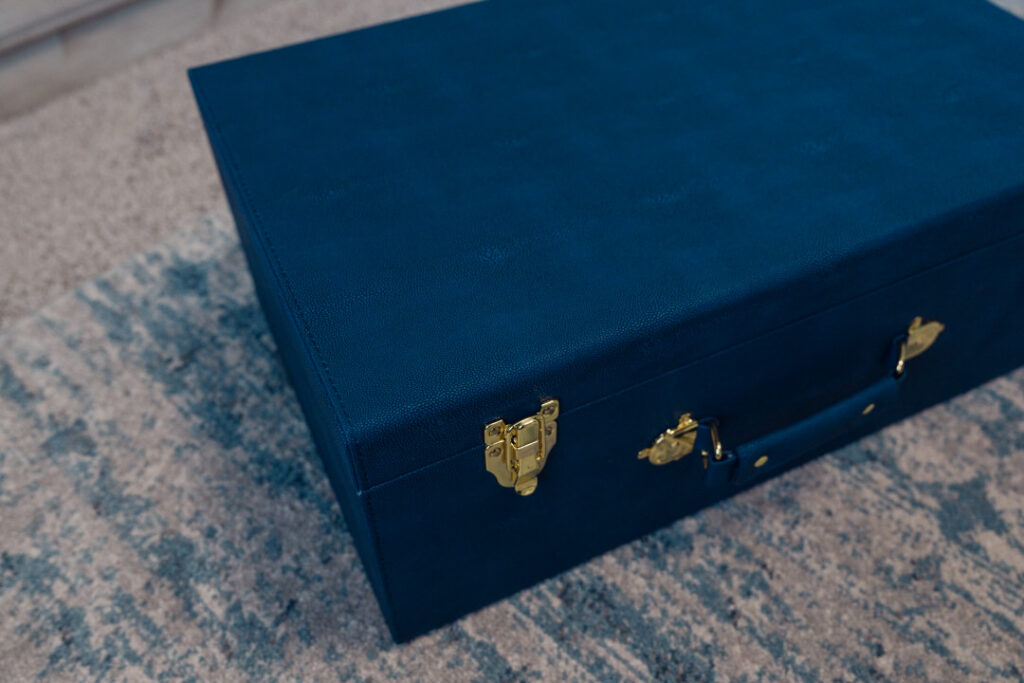 Close up detail of a faux leather blue keepsake trunk