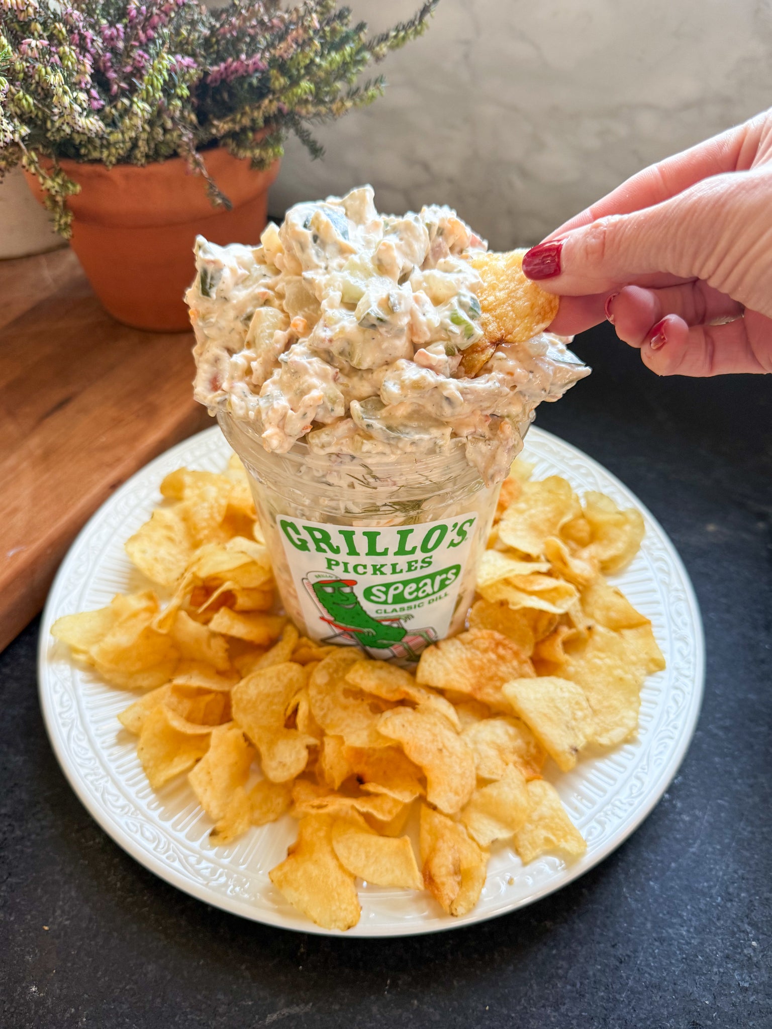 viral pickle dip using Grillo's pickles on a plate with chips

