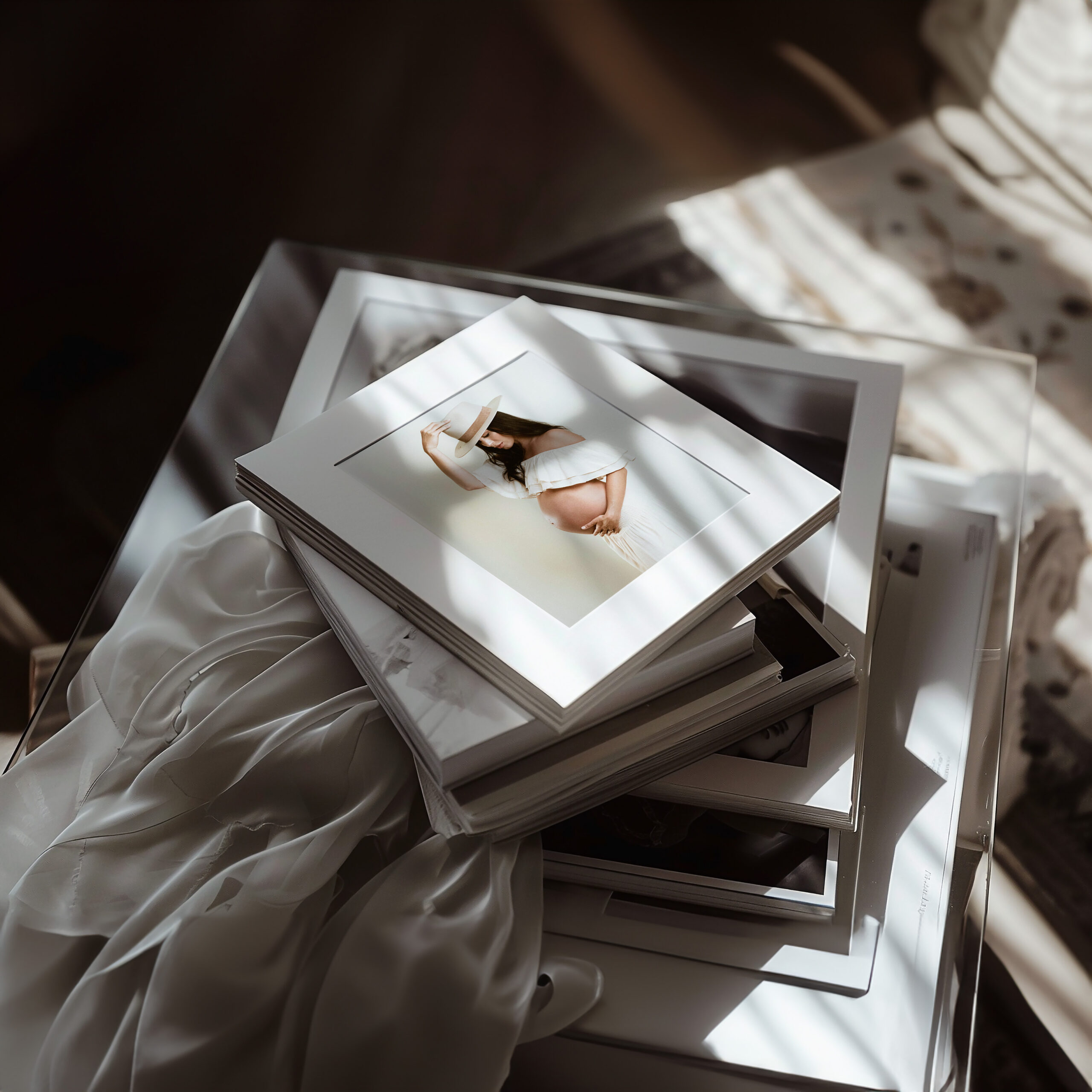 stack of artwork and framed family photography waiting to be hung on the wall